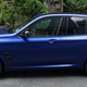 A photo of a blue 2022 BMW X3 M Competition.